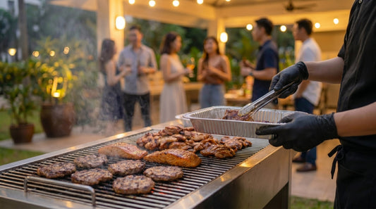 BBQ chef grilling Angus beef, teriyaki salmon, and chicken at a private outdoor gathering in Singapore — The Smokehouse Collective BBQ chef service