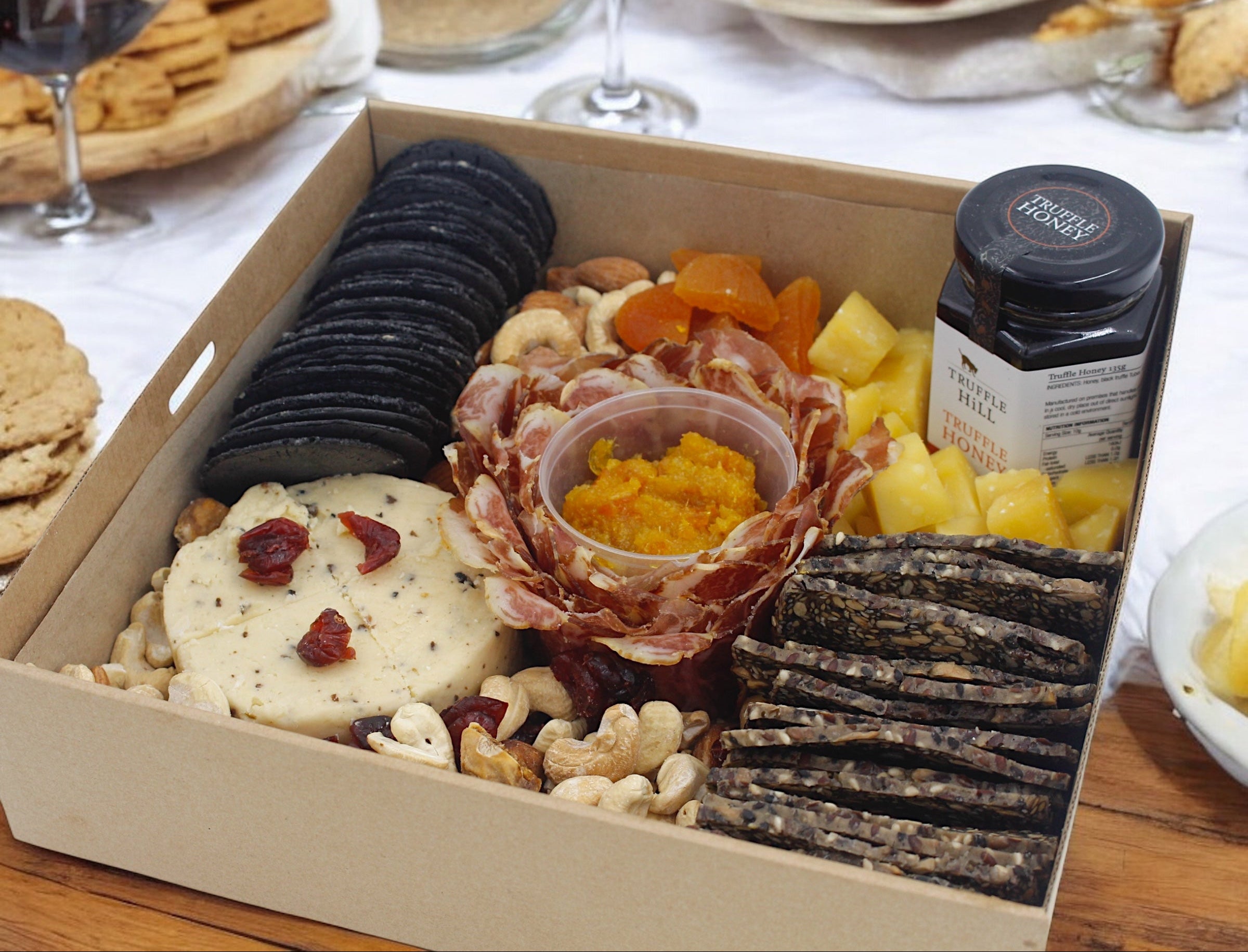 Regular Truffle Meat and Cheese Platter at a gathering — cheese board with truffle honey and cold cuts Singapore